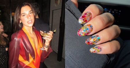 Unhas de Dua Lipa inspiram nail art colorida perfeita para o Carnaval Cantora Dua Lipa posa em evento segurando uma taça, enquanto detalhe mostra unhas com nail art colorida estilo confete, com base translúcida e bolinhas multicoloridas, inspirando tendência para o Carnaval 2026.